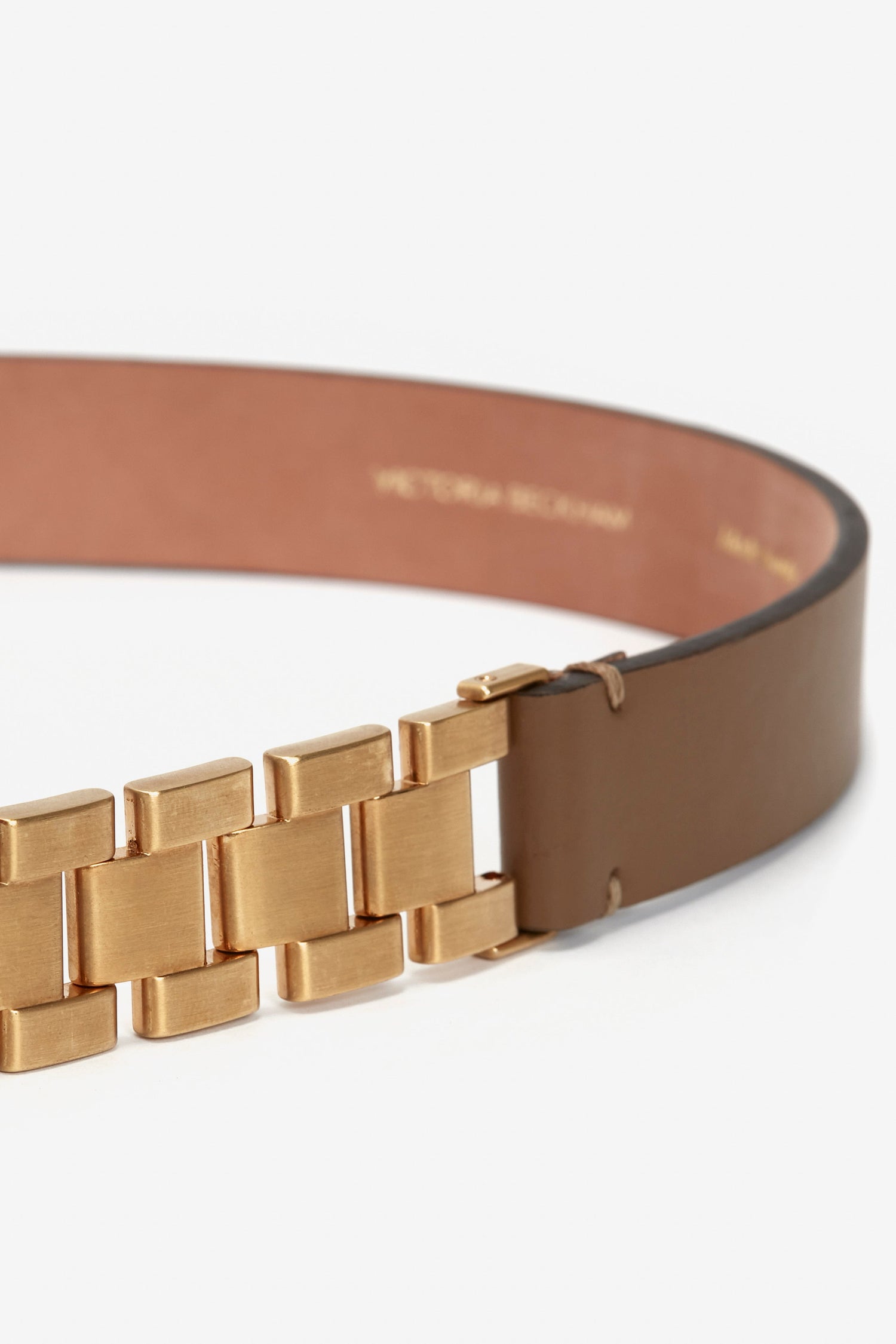 Watch Strap Detail Belt in Khaki-Brown by Victoria Beckham with a unique gold-toned brick-like buckle, set against a white background.