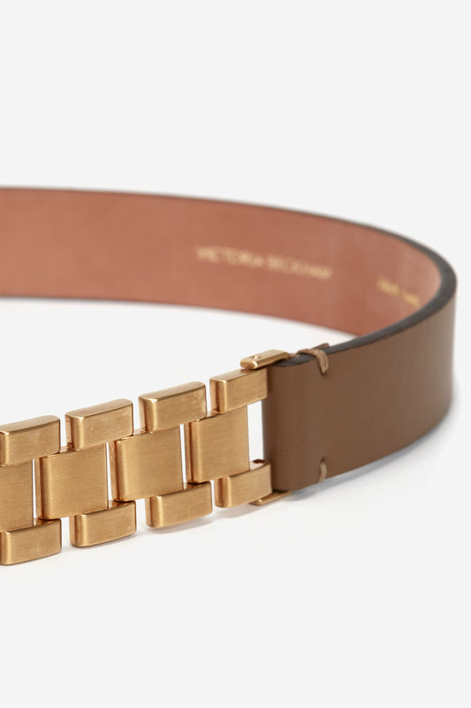 Watch Strap Detail Belt in Khaki-Brown by Victoria Beckham with a unique gold-toned brick-like buckle, set against a white background.