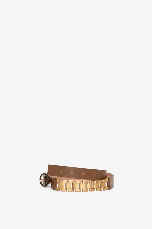 Golden-brown Watch Strap Detail Belt in Khaki-Brown from Victoria Beckham with a metallic gold buckle and matching gold square studs, displayed against a white background.