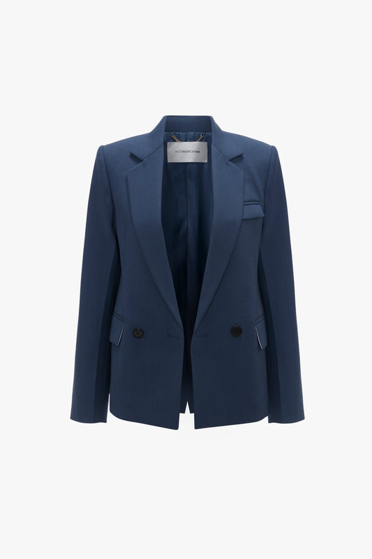 A Victoria Beckham Shrunken Double Breasted Jacket In Heritage Blue with notched lapels and button details, displayed against a white background.