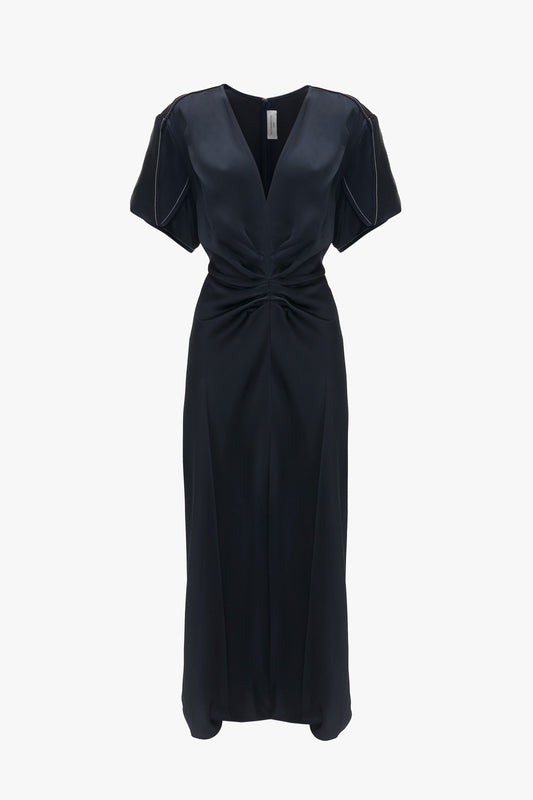 An Exclusive Gathered V-Neck Midi Dress In Navy by Victoria Beckham with short sleeves and a knotted detail at the waist, displayed against a white background.