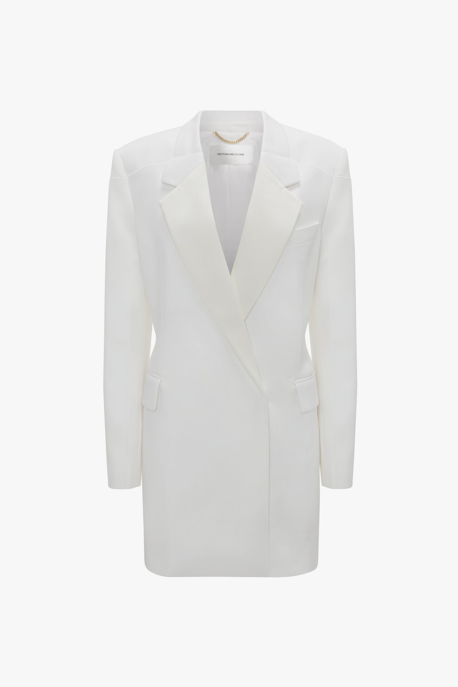 Double-breasted white tuxedo-style long jacket with peaked lapels and two side flap pockets, isolated on a white background from Victoria Beckham's Exclusive Fold Shoulder Detail Dress In Ivory collection.