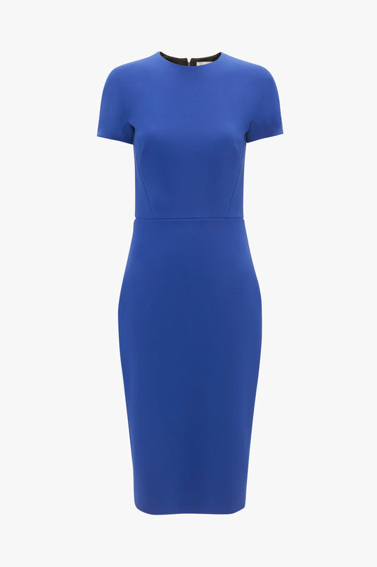 A Palace Blue, knee-length wool crepe sheath dress with short sleeves and a round neckline, displayed on a white background by Victoria Beckham.