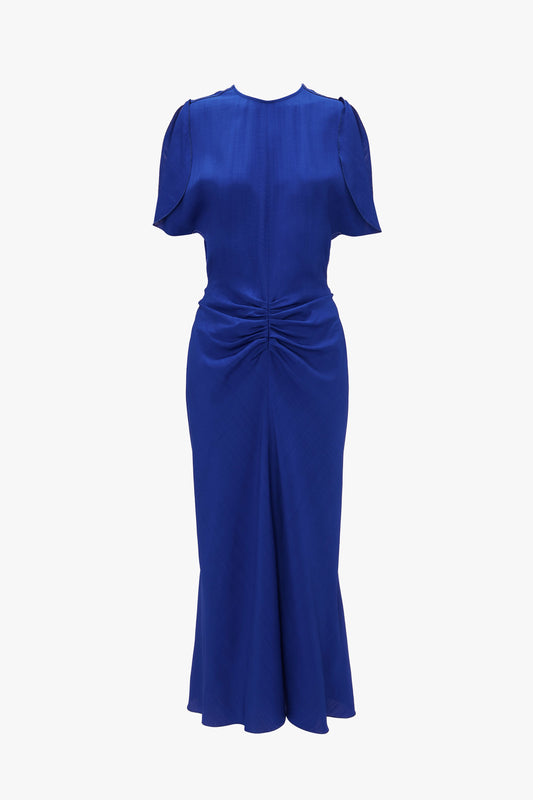 Victoria Beckham's Gathered Waist Midi Dress In Palace Blue with cap sleeves and a twist detail at the waist, displayed on a white background.