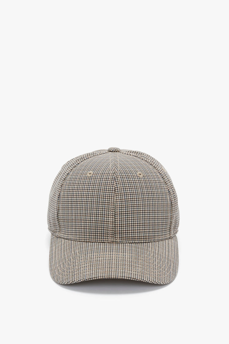A Logo Cap In Dogtooth Check by Victoria Beckham facing front, displayed against a white background, features an adjustable plastic snap.