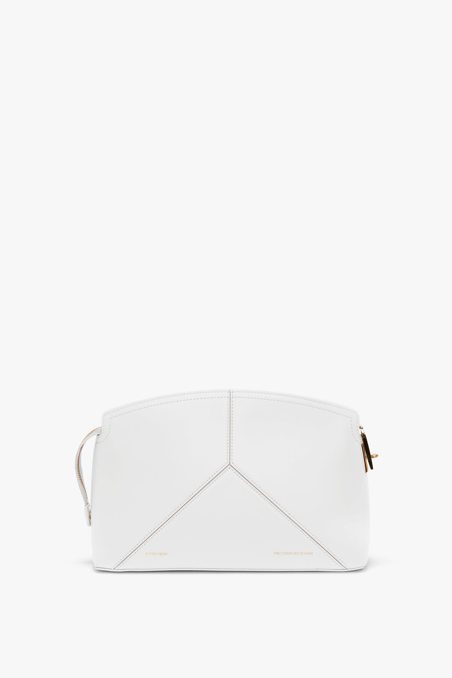 A white geometric handbag with gold hardware and minimal stitching, featuring a top-zip closure and a branded padlock for added security.
Product Name: Exclusive Victoria Clutch Bag In White Leather Brand Name: Victoria Beckham
Replaced Sentence:
The Exclusive Victoria Clutch Bag In White Leather by Victoria Beckham features a white geometric design with gold hardware and minimal stitching, complemented by a top-zip closure and a branded padlock for added security.