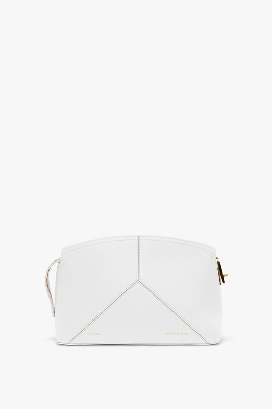 A white geometric handbag with gold hardware and minimal stitching, featuring a top-zip closure and a branded padlock for added security.
Product Name: Exclusive Victoria Clutch Bag In White Leather Brand Name: Victoria Beckham
Replaced Sentence:
The Exclusive Victoria Clutch Bag In White Leather by Victoria Beckham features a white geometric design with gold hardware and minimal stitching, complemented by a top-zip closure and a branded padlock for added security.