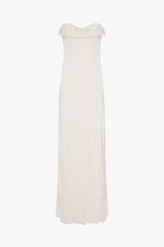 A plain, off-white maxi dress with a strapless sweetheart neckline and a slightly crinkled texture, displayed against a white background. 
Product Name: Victoria Beckham Exclusive Floor-Length Corset Detail Gown In Ivory