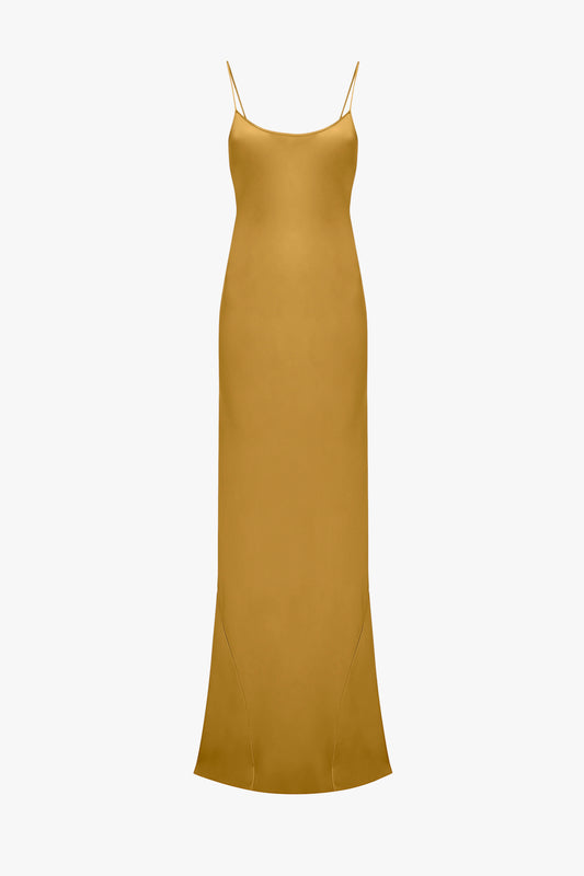 Victoria Beckham Low Back Cami Floor-Length Dress in Harvest Gold with spaghetti straps and a straight neckline, displayed on a plain white background.