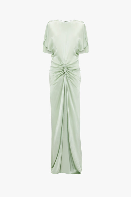 Exclusive floor-length gathered dress in jade by Victoria Beckham featuring short sleeves, a round neckline, and an open back with a cinched, draped waist, isolated on a white background.