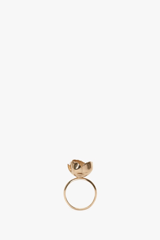 Exclusive Camellia Flower Ring In Gold by Victoria Beckham featuring an intricate Camellia flower design on the top, isolated on a white background.
