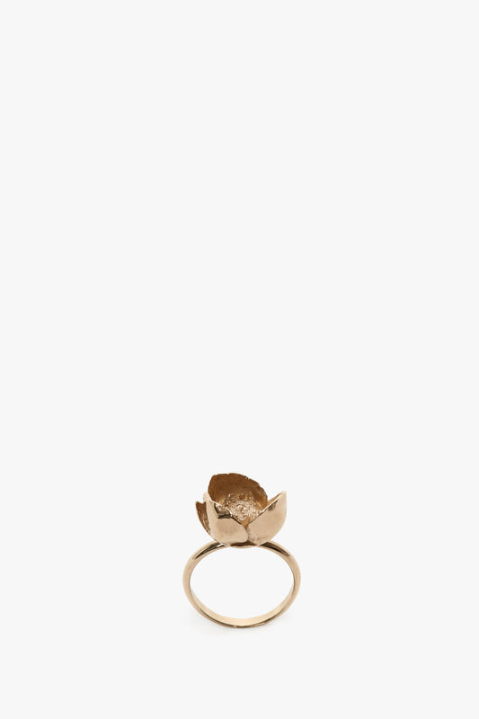 Exclusive Camellia Flower Ring in Gold by Victoria Beckham isolated on a white background.