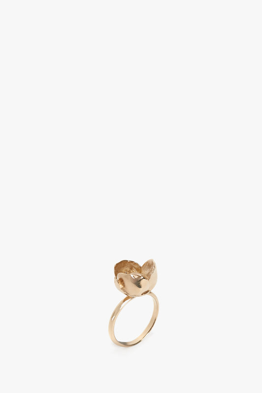 Exclusive Camellia Flower Ring In Gold-plated brass with a heart-shaped motif on a white background by Victoria Beckham.