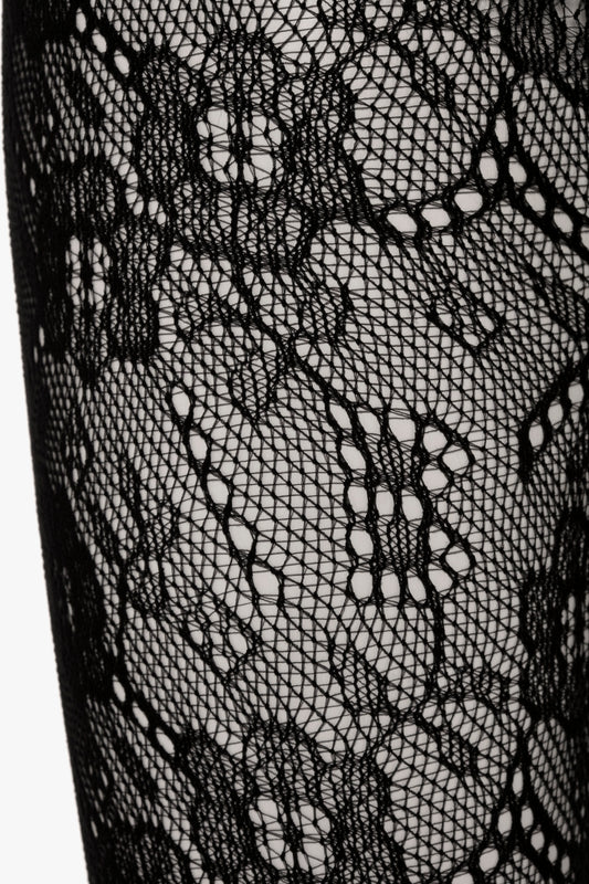 Close-up view of a Victoria Beckham Exclusive VB Monogram Lace Tights In Black showing detailed floral patterns and mesh texturing, crafted with denier-40 for a seamless and sag-free construction.