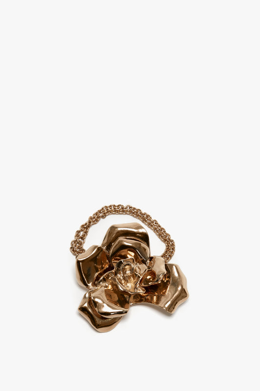 Exclusive Flower Bracelet In Gold with an adjustable chain handle on a white background by Victoria Beckham.