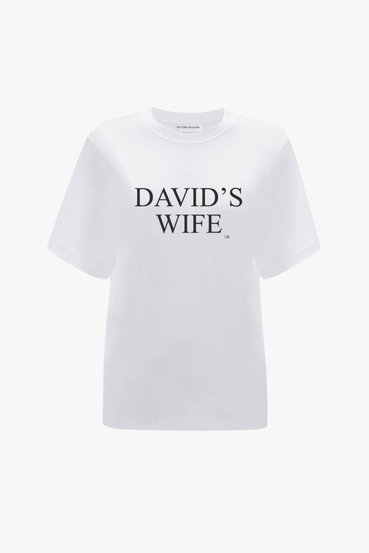 Victoria Beckham's 'David's Wife' Slogan T-Shirt in White, made of organic cotton and featuring the phrase printed in black letters on the front, displayed on a plain background.