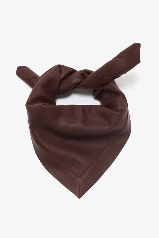 A Foulard In Bordeaux Leather with a tied knot, isolated on a white background by Victoria Beckham.