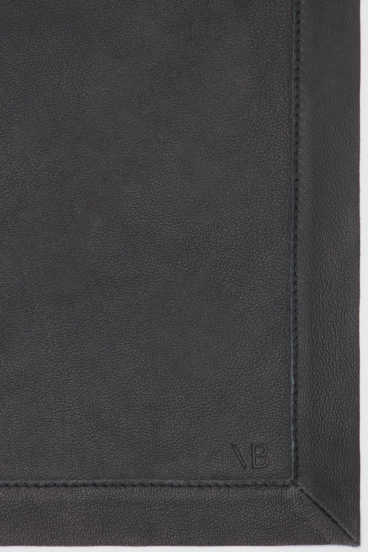 Close-up of a Victoria Beckham Foulard In Black Leather with a subtle embossed logo at the bottom and visible stitching on the sides.