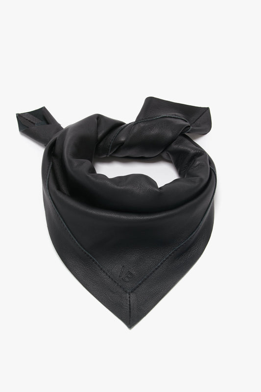 Black Foulard In Black Leather bandana by Victoria Beckham, neatly folded into a triangular shape, isolated on a white background.