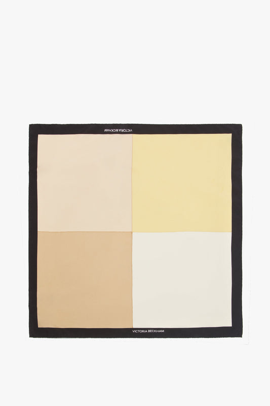 A Victoria Beckham Colour Block Foulard In Macadamia made from luxurious printed silk twill, featuring a geometric design in shades of beige, yellow, and white, displayed against a plain background.