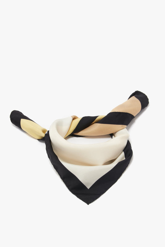 A twisted printed silk twill scarf with alternating black and cream stripes against a white background. (Colour Block Foulard In Macadamia by Victoria Beckham)