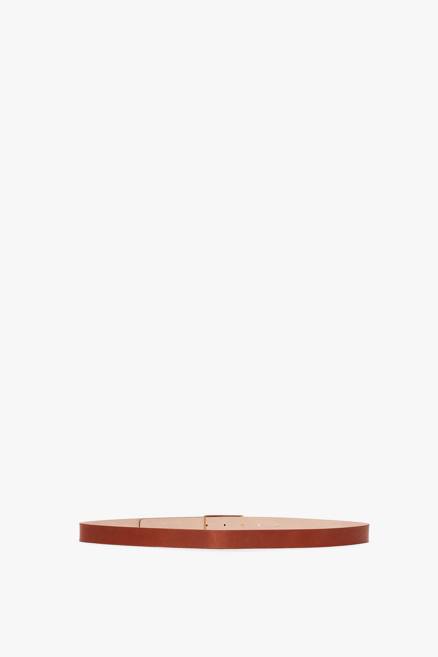 A slender brown Victoria Beckham calf leather belt with a simple gold-tone Exclusive Frame buckle, displayed against a plain white background.