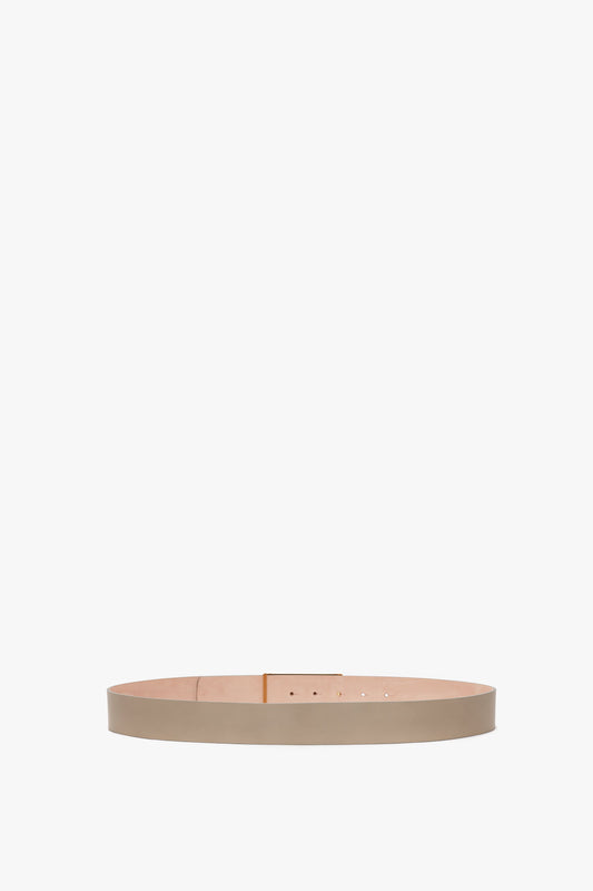 A plain beige calf leather Exclusive Jumbo Frame Belt by Victoria Beckham displayed against a white background, showing buckle holes and a seamless design with no buckle attached.