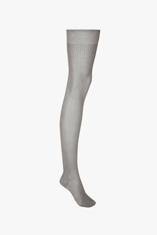 A single exclusive over the knee sock in grey by Victoria Beckham displayed against a white background, ideal for your autumn winter wardrobe.
