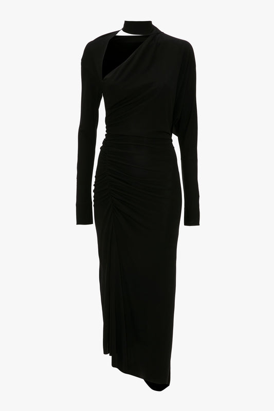 A black Victoria Beckham long-sleeve dress with an asymmetric cut-out neckline and gathered details on the side, displayed on a mannequin against a white background.