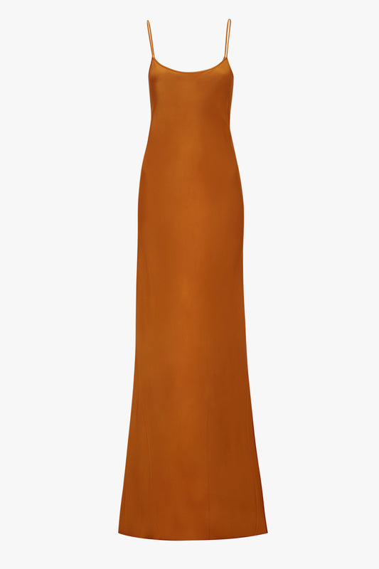 Sleeveless, orange midi dress crafted from crepe back satin in a camisole-slip style with thin straps, displayed against a plain background Victoria Beckham.