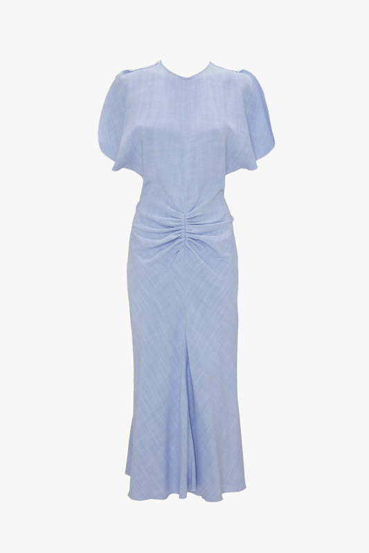 Light blue "Gathered Waist Midi Dress In Frost" with puff sleeves and a twisted knot detail at the waist, displayed against a white background by Victoria Beckham.