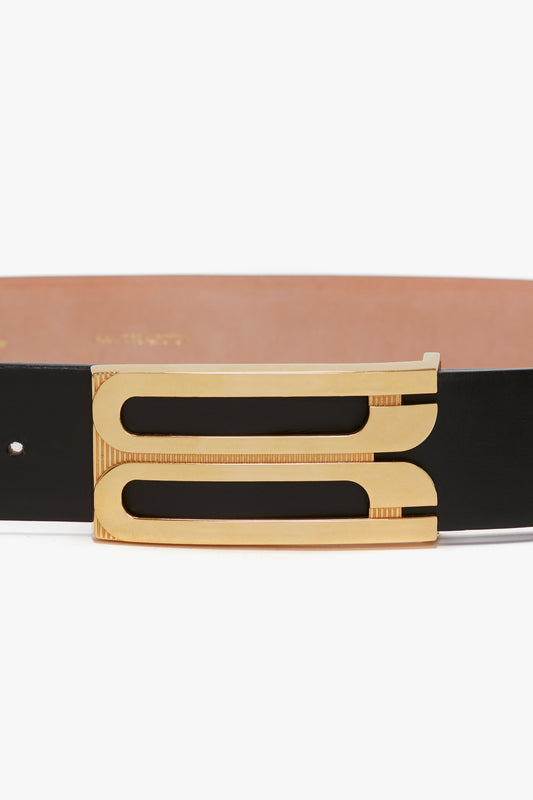 Close-up of a black calf leather Exclusive Jumbo Frame Belt by Victoria Beckham with a detailed gold buckle against a white background.