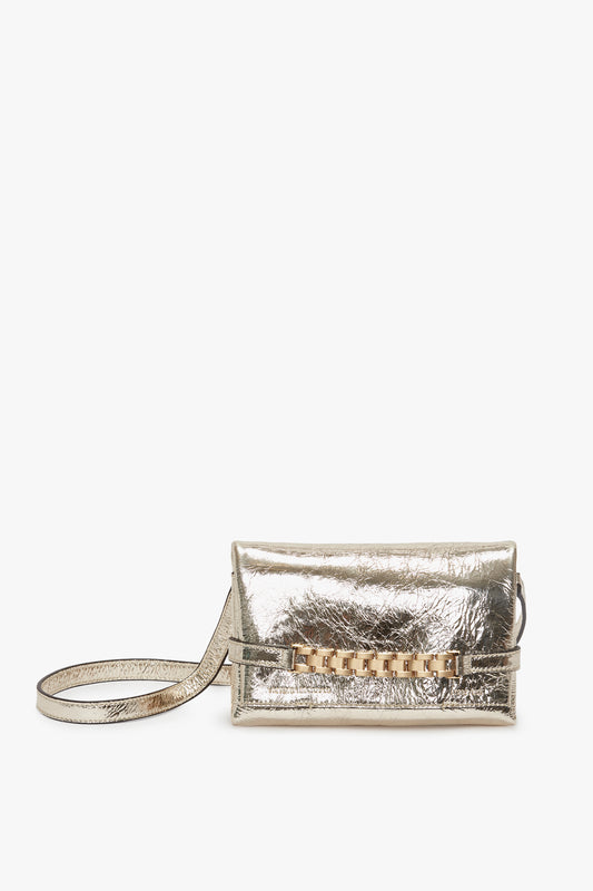 Victoria Beckham Mini Chain Pouch With Long Strap In Gold Leather with wrist strap and front flap closure, displayed against a white background.