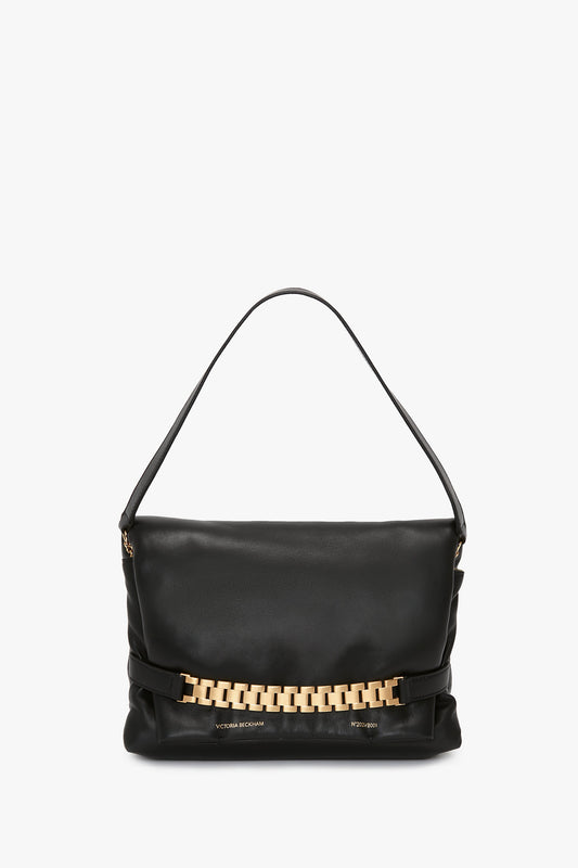 Puffy Chain Pouch With Strap In Black Leather handbag with a gold chain detail on the front, isolated on a white background by Victoria Beckham.