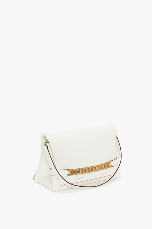 Chain Pouch with Strap in White Leather by Victoria Beckham, with gold zipper accents and a fold-over top, photographed on a blank background.