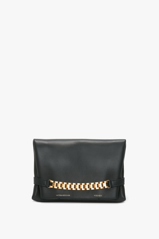 Chain Pouch Bag In Black Leather Victoria Beckham clutch with gold-tone hardware, isolated on a white background.