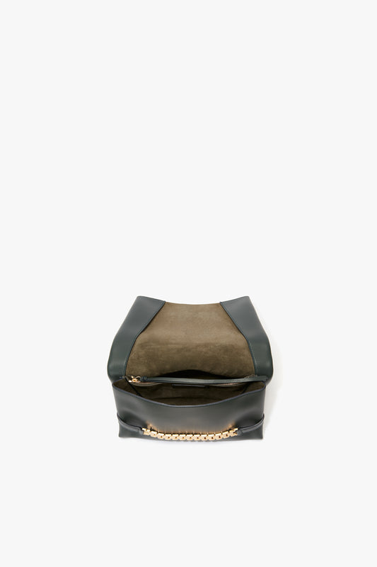 A stylish Victoria Beckham black leather chain pouch bag with gold-tone hardware, displayed against a white background.