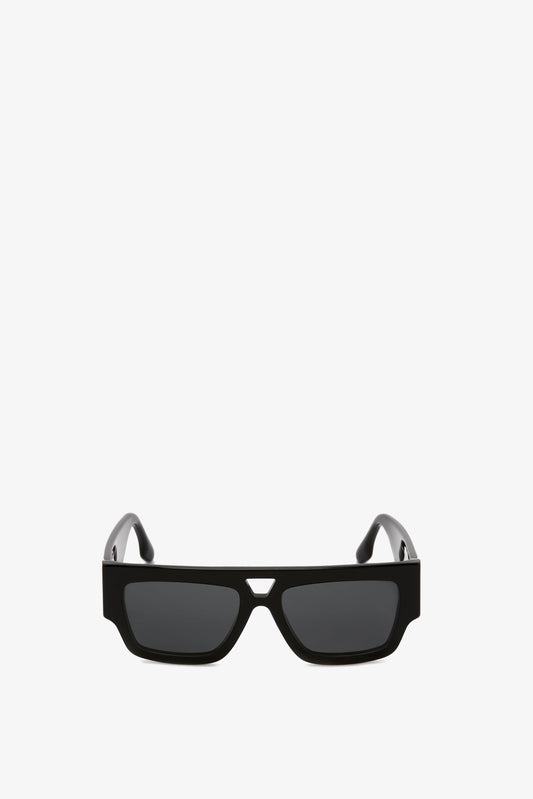 A pair of Victoria Beckham V Plaque Frame Sunglasses in Black with a sleek design and high-shine acetate frame, isolated on a white background.