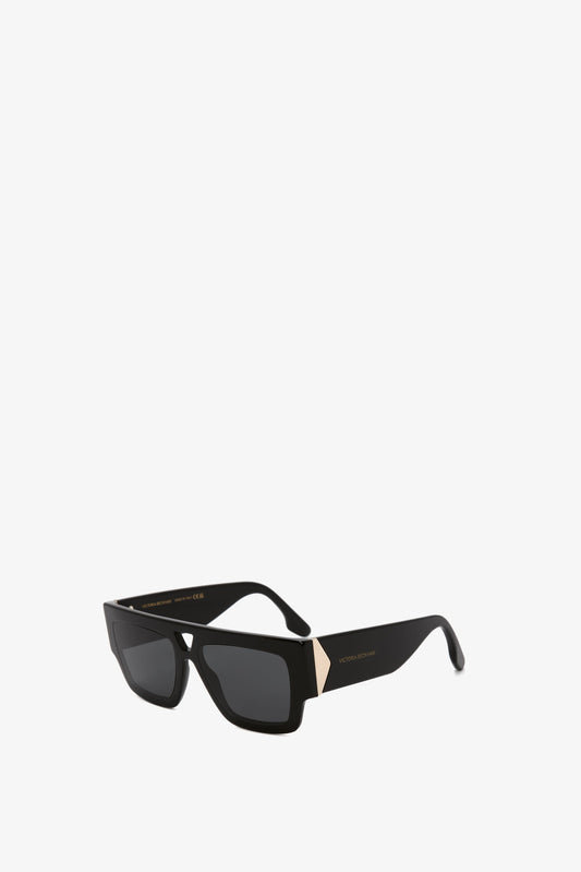 Victoria Beckham V Plaque Frame Sunglasses In Black, isolated on a white background.