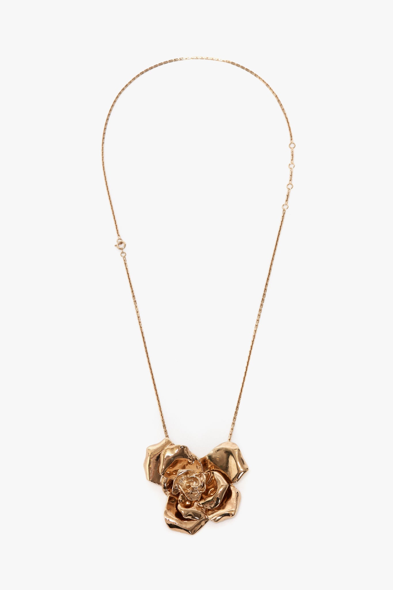 This Exclusive Flower Necklace In Gold by Victoria Beckham is a statement accessory featuring a large, intricately designed flower pendant with textured petals, crafted from gold brushed brass.