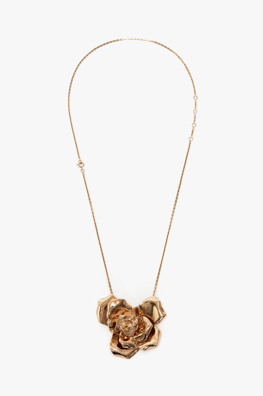 This Exclusive Flower Necklace In Gold by Victoria Beckham is a statement accessory featuring a large, intricately designed flower pendant with textured petals, crafted from gold brushed brass.
