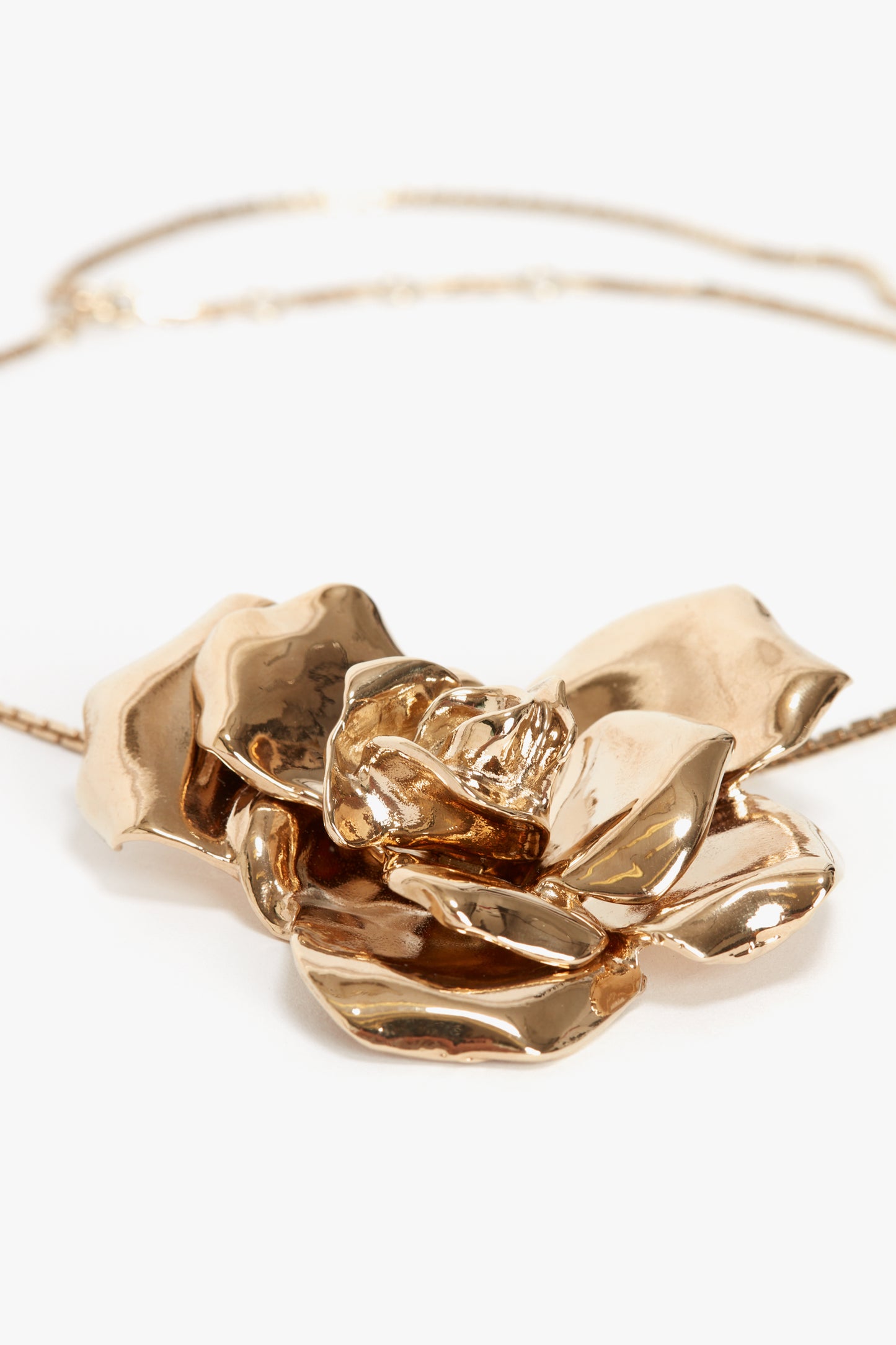 A gold brushed brass necklace featuring a large flower-shaped pendant, the Exclusive Flower Necklace In Gold by Victoria Beckham is the perfect statement accessory.