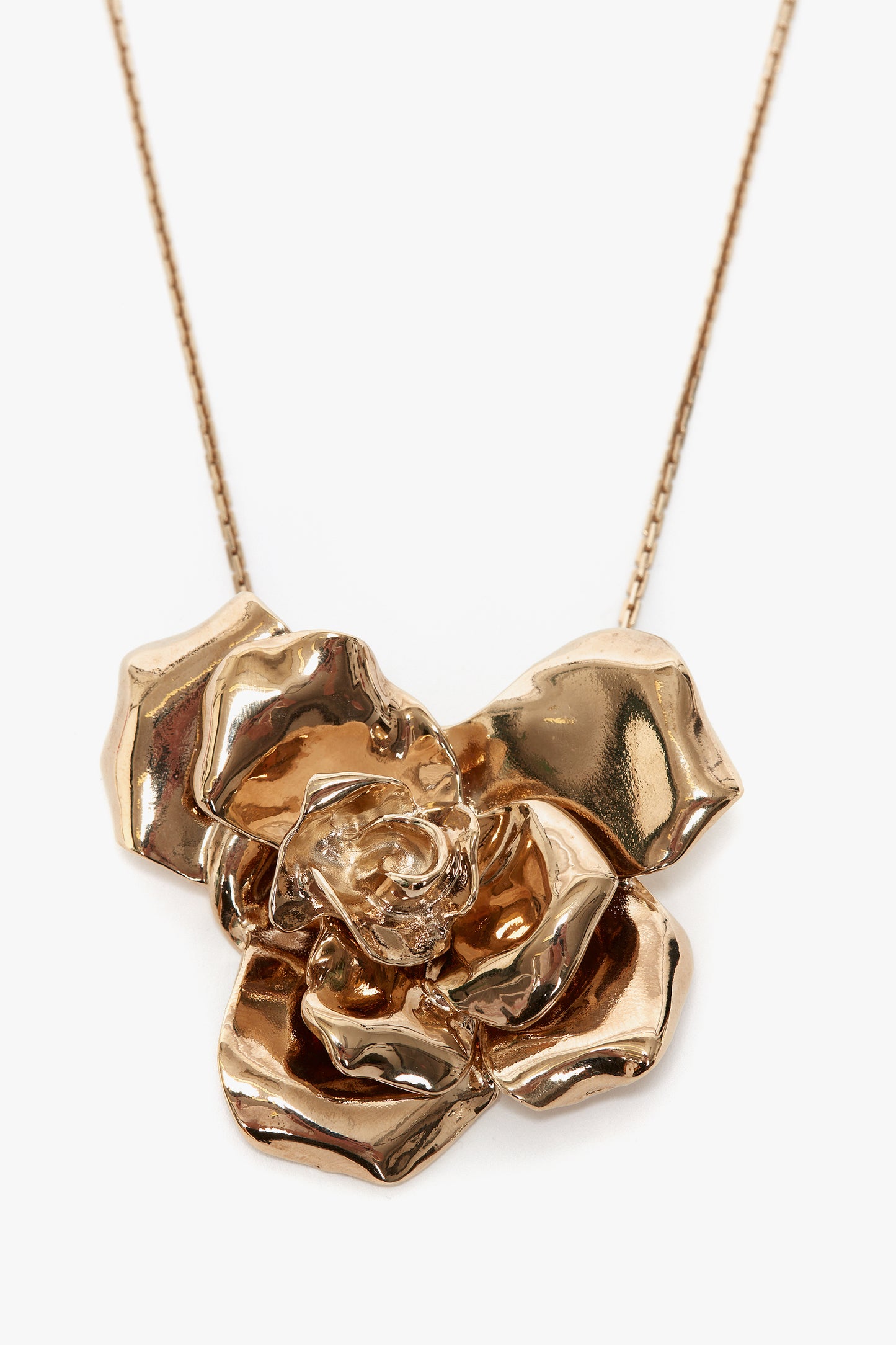 The Victoria Beckham Exclusive Flower Necklace In Gold on a delicate chain makes a perfect statement accessory.