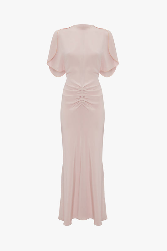Elegant pale pink evening dress with tulip sleeves, a cinched waist, and a gathered detail at the front, displayed against a white background. (Gathered Waist Midi Dress In Blush by Victoria Beckham)