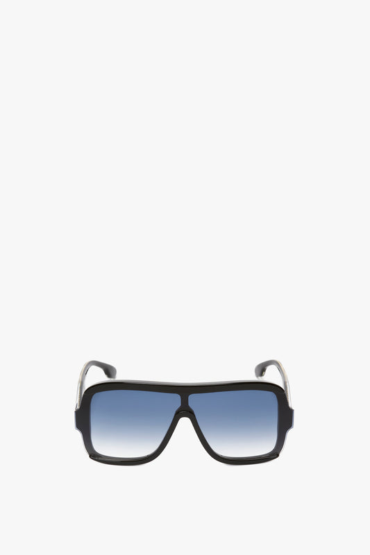 A pair of Victoria Beckham Layered Mask Sunglasses in black gradient with blue tinted lenses and silver accents on the temples, isolated on a white background.