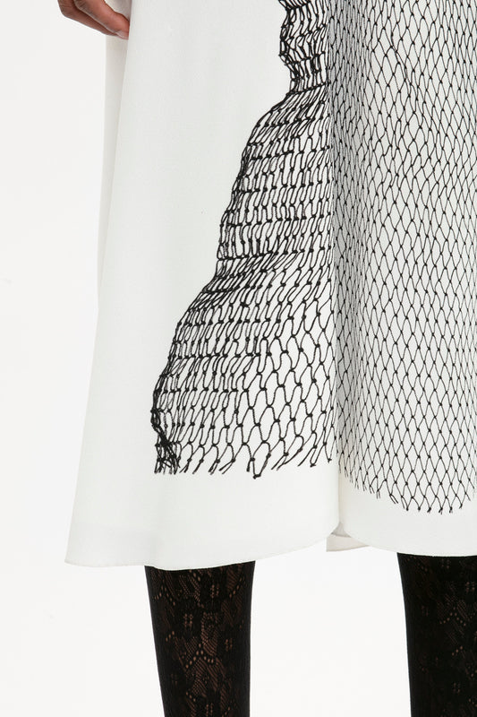 A close up of a Victoria Beckham Gathered Waist Midi Dress In White-Black Contorted Net.