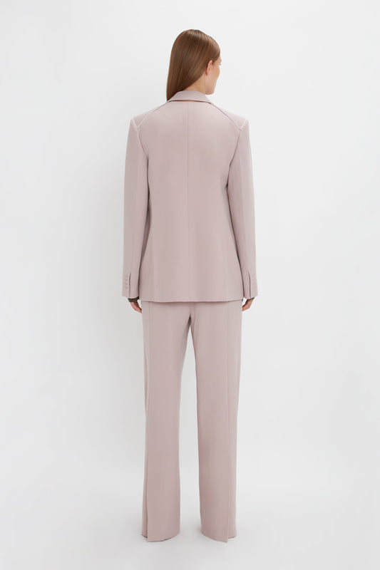 Person wearing a Victoria Beckham Double Panel Front Jacket in Rose Quartz and matching trousers, standing facing away from the camera against a plain white background.