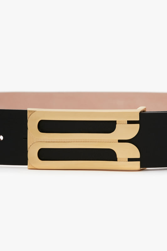 A stylish **Exclusive Jumbo Frame Belt In Navy Leather** crafted from premium calf leather, featuring a rectangular gold buckle with an open, modern design by **Victoria Beckham**.