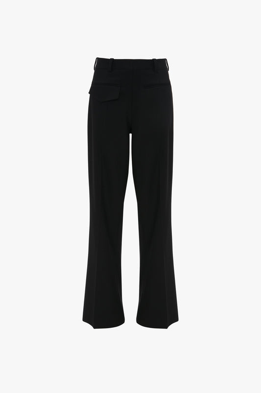 Black dress pants with a single back pocket, belt loops, and slightly flared legs. Designed for the modern woman, the Reverse Front Trouser In Black by Victoria Beckham showcases a contemporary silhouette while being shown from the back.
