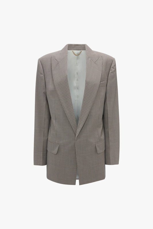 Victoria Beckham's Peak Lapel Jacket In Multi is a brown plaid, single-breasted blazer with an oversized silhouette, featuring a notched lapel and two front pockets, shown on a white background.